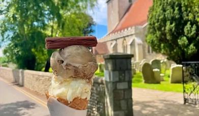 an ice cream against the backdrop of Bosham Church