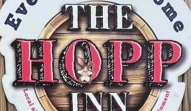A sign for The Hopp Inn