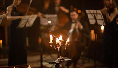 The Piccadilly Sinfonietta performing in a candlelit church