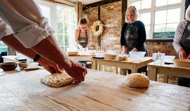 people making bread in a room