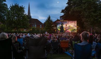 Image of the film "Wicked" on a large screen in Priory Park