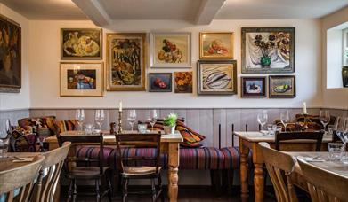 Inside The Horse and Groom, East Ashling showing the cosy pub with chair and tables