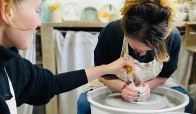 a person using a pottery wheel
