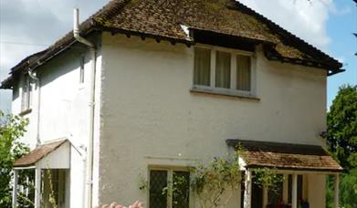 Surrounded with beautiful gardens, orchards and sunken wood