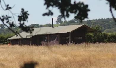 a safari tent in a field